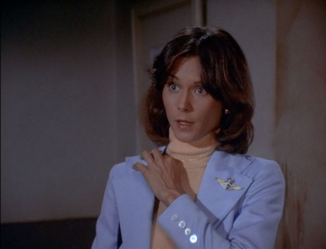 Sabrina tucks her necklace